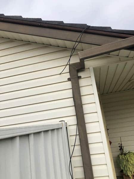 Exposed cables running down the side of house